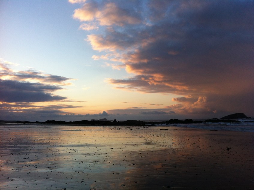 Sunset over shining sands on beach